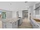Bright open kitchen features granite counters, an island with a sink, and access to other rooms at 4265 E John St, Gilbert, AZ 85295
