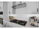 Modern kitchen with white cabinets, subway tile backsplash, stainless hood, and granite countertops at 4265 E John St, Gilbert, AZ 85295