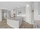 Open kitchen features granite countertops, white cabinets, subway tile backsplash, and stainless steel vent hood at 4265 E John St, Gilbert, AZ 85295