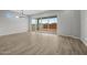 Bright living room with tile floors, a modern chandelier, and large sliding glass doors that showcase the backyard at 4265 E John St, Gilbert, AZ 85295