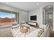 Comfortable living room with sliding glass doors to the backyard, featuring neutral colors and contemporary furnishings at 4265 E John St, Gilbert, AZ 85295