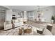 Cozy living room with a comfortable sofa, modern decor, and an open layout to the dining and kitchen areas at 4265 E John St, Gilbert, AZ 85295