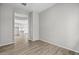 Bright living room featuring wood tile flooring and an archway leading to the kitchen at 4265 E John St, Gilbert, AZ 85295