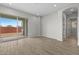Open-concept living room with sliding glass doors to the backyard, featuring modern flooring and neutral paint at 4265 E John St, Gilbert, AZ 85295