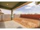 A spacious, covered patio with a view to new landscaping and a block fence at 4265 E John St, Gilbert, AZ 85295