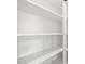 A full view of an empty set of bright white shelves at 4265 E John St, Gilbert, AZ 85295