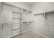 Spacious walk-in closet with built-in shelves and hanging rods at 4265 E John St, Gilbert, AZ 85295