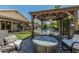 Backyard featuring an outdoor seating area, fire pit, and view of pool, lawn, and home at 4665 E Goldfinch Gate Ln, Phoenix, AZ 85044
