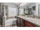 Elegant bathroom featuring dual sinks, granite countertops, and a separate shower and bathtub at 4665 E Goldfinch Gate Ln, Phoenix, AZ 85044