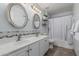 Bright bathroom featuring dual sinks, chrome fixtures, and a shower-tub combination at 4665 E Goldfinch Gate Ln, Phoenix, AZ 85044