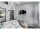 Comfortable bedroom featuring a queen bed, hardwood floors, and a wall-mounted TV at 4665 E Goldfinch Gate Ln, Phoenix, AZ 85044