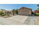 Inviting single-story home featuring a two-car garage and desert landscaping with a paved driveway at 4665 E Goldfinch Gate Ln, Phoenix, AZ 85044