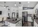 Modern kitchen featuring white cabinets, stainless steel appliances, and an island with a sink at 4665 E Goldfinch Gate Ln, Phoenix, AZ 85044