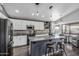 Modern kitchen featuring white cabinets, a large island with seating, and stainless steel appliances at 4665 E Goldfinch Gate Ln, Phoenix, AZ 85044
