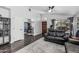 Spacious living room with an open floor plan, wood floors, and a view of the home office at 4665 E Goldfinch Gate Ln, Phoenix, AZ 85044