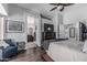 Bright main bedroom with a wooden bed frame, ceiling fan, and ensuite bathroom access at 4665 E Goldfinch Gate Ln, Phoenix, AZ 85044