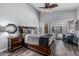 Spacious main bedroom with a wooden bed frame, ceiling fan, and direct access to the outdoors at 4665 E Goldfinch Gate Ln, Phoenix, AZ 85044