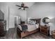 Relaxing main bedroom with a wooden bed frame, hardwood floors, and ample natural light at 4665 E Goldfinch Gate Ln, Phoenix, AZ 85044