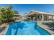 Beautiful swimming pool surrounded by patio, outdoor kitchen, landscaped areas, and a gazebo at 4665 E Goldfinch Gate Ln, Phoenix, AZ 85044