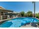 Inviting backyard pool with sunshade, lounge seating, and tropical landscaping, great for relaxing at 4665 E Goldfinch Gate Ln, Phoenix, AZ 85044