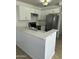 Modern kitchen featuring white cabinets, stainless steel appliances, and quartz countertops at 510 N Alma School Rd # 259, Mesa, AZ 85201