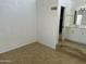 Sunlit main bedroom with tiled floor that leads into the main bathroom at 510 N Alma School Rd # 259, Mesa, AZ 85201