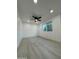 Cozy bedroom featuring a ceiling fan, neutral wall paint, bright window, and modern floors at 5431 W Cholla St, Glendale, AZ 85304