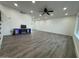 Spacious living room featuring modern floors, recessed lighting, a fireplace, and several windows at 5431 W Cholla St, Glendale, AZ 85304