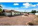 Backyard view featuring fountain, mature trees, and brick-lined landscaping at 5434 E Acoma Dr, Scottsdale, AZ 85254
