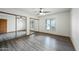 Bright bedroom with a large closet, mirrored doors, a ceiling fan, and a window at 5434 E Acoma Dr, Scottsdale, AZ 85254