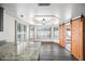 Bright dining area featuring stylish lighting, shuttered windows, granite counters, and barn door at 5434 E Acoma Dr, Scottsdale, AZ 85254