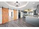 Open dining area showcasing a barn door, chandelier, modern flooring and granite counters at 5434 E Acoma Dr, Scottsdale, AZ 85254
