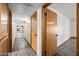 Hallway with wood doors and trim, leading to various rooms in the house at 5434 E Acoma Dr, Scottsdale, AZ 85254