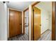 Hallway with three doors leading to other rooms, including one to the mirrored bedroom in the distance at 5434 E Acoma Dr, Scottsdale, AZ 85254