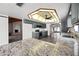 Kitchen featuring grey cabinetry, stone countertops, stainless appliances, and open to the living room at 5434 E Acoma Dr, Scottsdale, AZ 85254
