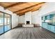 Living room featuring vaulted ceilings, modern floors, a brick fireplace, and a wet bar with built-ins at 5434 E Acoma Dr, Scottsdale, AZ 85254
