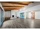 Living room boasts a brick fireplace, a wet bar with built-ins, a vaulted ceiling, and modern flooring at 5434 E Acoma Dr, Scottsdale, AZ 85254