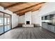 Spacious living room features a brick fireplace, wet bar, exposed beam ceiling, and sliding glass door at 5434 E Acoma Dr, Scottsdale, AZ 85254