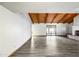 Spacious living room featuring a vaulted ceiling, brick fireplace, sliding glass doors and modern flooring at 5434 E Acoma Dr, Scottsdale, AZ 85254