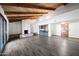 Open living room boasts exposed beams, a fireplace, a wet bar area, and access to the backyard at 5434 E Acoma Dr, Scottsdale, AZ 85254