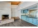 Open-concept living area features a brick fireplace, a wet bar with built-ins and a vaulted ceiling at 5434 E Acoma Dr, Scottsdale, AZ 85254