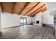 Bright living room features exposed beam ceiling, fireplace, and a sliding glass door to the sunroom at 5434 E Acoma Dr, Scottsdale, AZ 85254