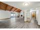 Spacious living room with wood beam ceiling, fireplace, and sliding glass doors at 5434 E Acoma Dr, Scottsdale, AZ 85254