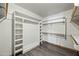 Organized walk-in closet with built-in shelving and hanging rods for ample storage space at 5434 E Acoma Dr, Scottsdale, AZ 85254