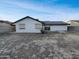 Exterior view of a one-story home with rolling window shutters and a spacious backyard at 5654 W Villa Theresa Dr, Glendale, AZ 85308