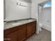 Bathroom featuring a double sink vanity with granite countertop and a shower/tub combo at 5654 W Villa Theresa Dr, Glendale, AZ 85308
