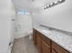 Bright bathroom featuring a granite countertop vanity with a shower-tub combo at 5654 W Villa Theresa Dr, Glendale, AZ 85308