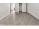 Unfurnished bedroom with tiled floors, closet and access to the bathroom at 5654 W Villa Theresa Dr, Glendale, AZ 85308