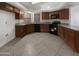 Well-equipped kitchen with granite countertops, stainless steel appliances, and wooden cabinets at 5654 W Villa Theresa Dr, Glendale, AZ 85308