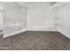 Empty living room featuring neutral walls, tiled floors and space for shelving at 5654 W Villa Theresa Dr, Glendale, AZ 85308